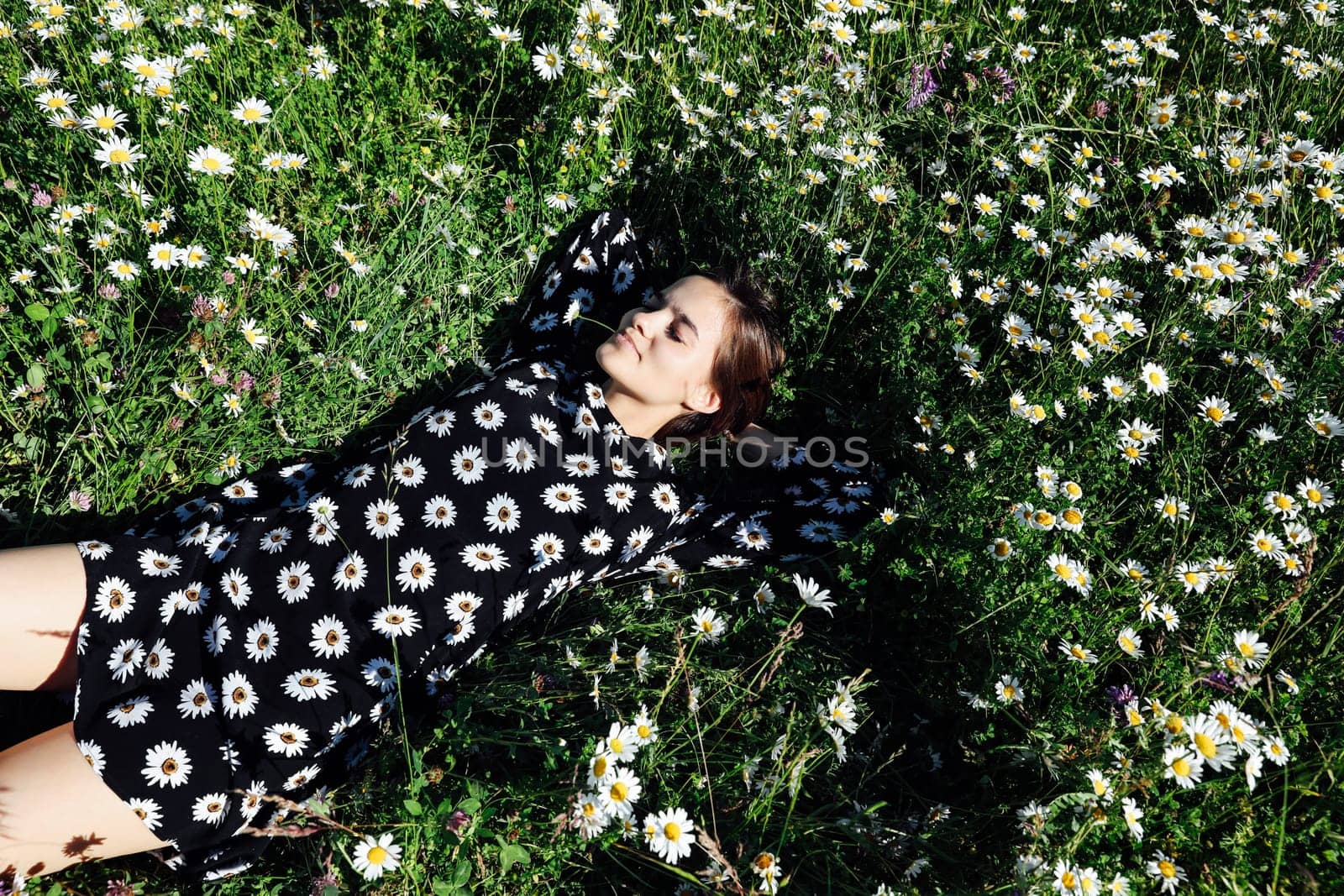 chamomile woman lying in field in flowers in nature walk journey