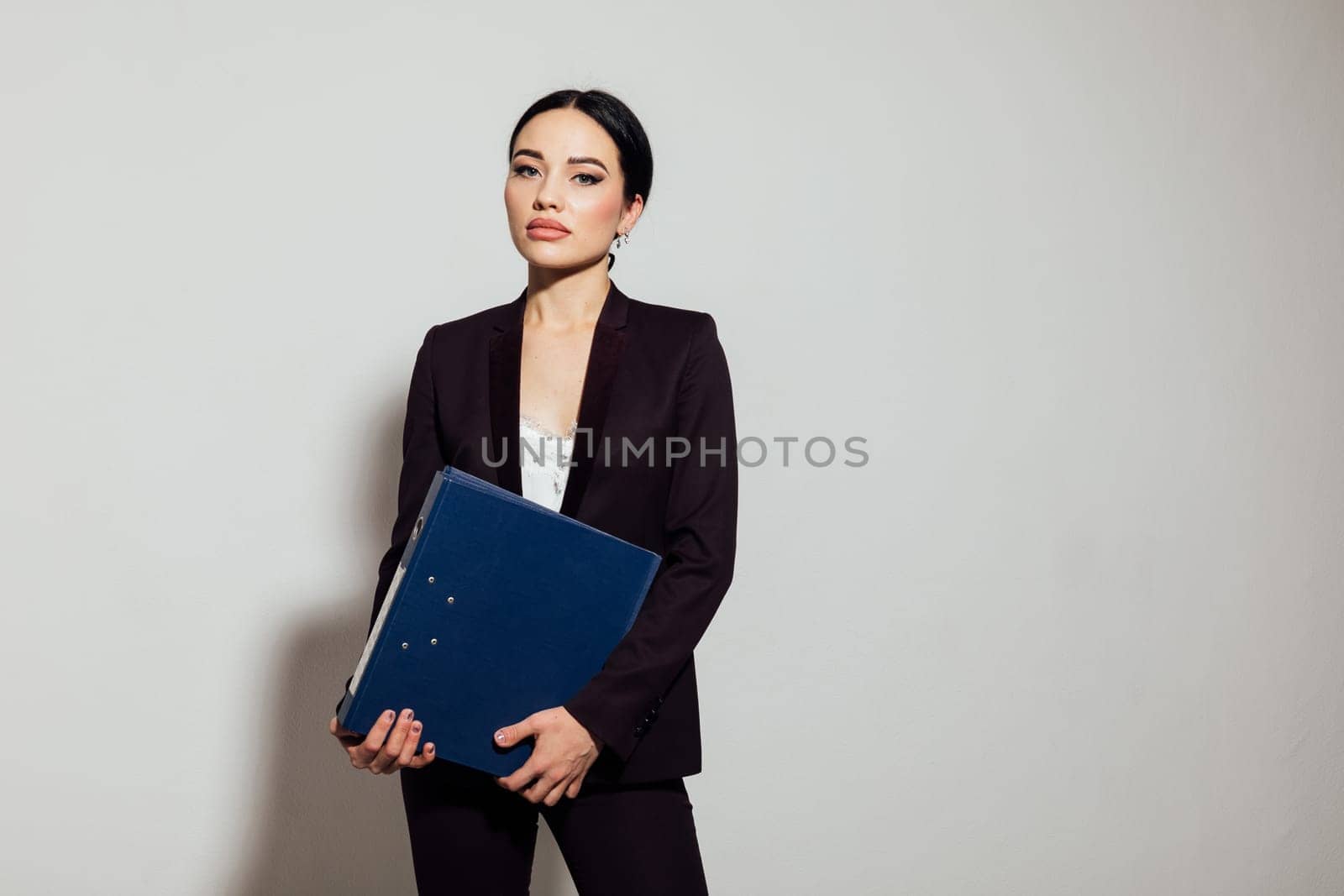 Woman in suit with folders in office space