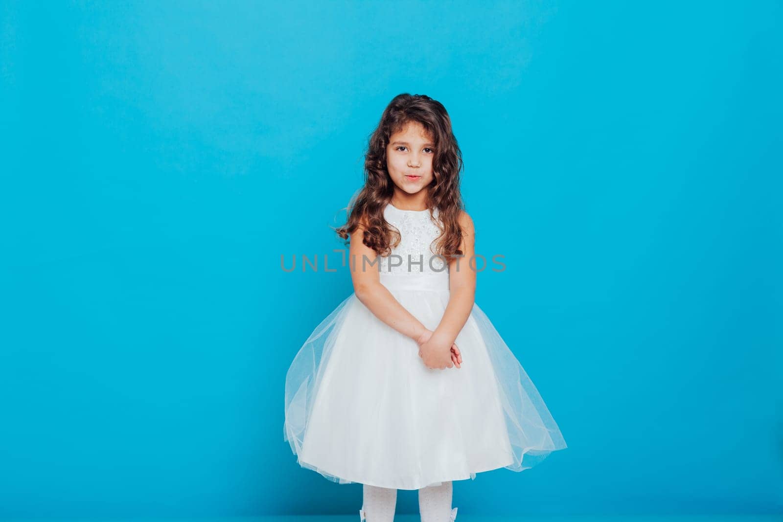 Girl in white dress on a blue background Holiday