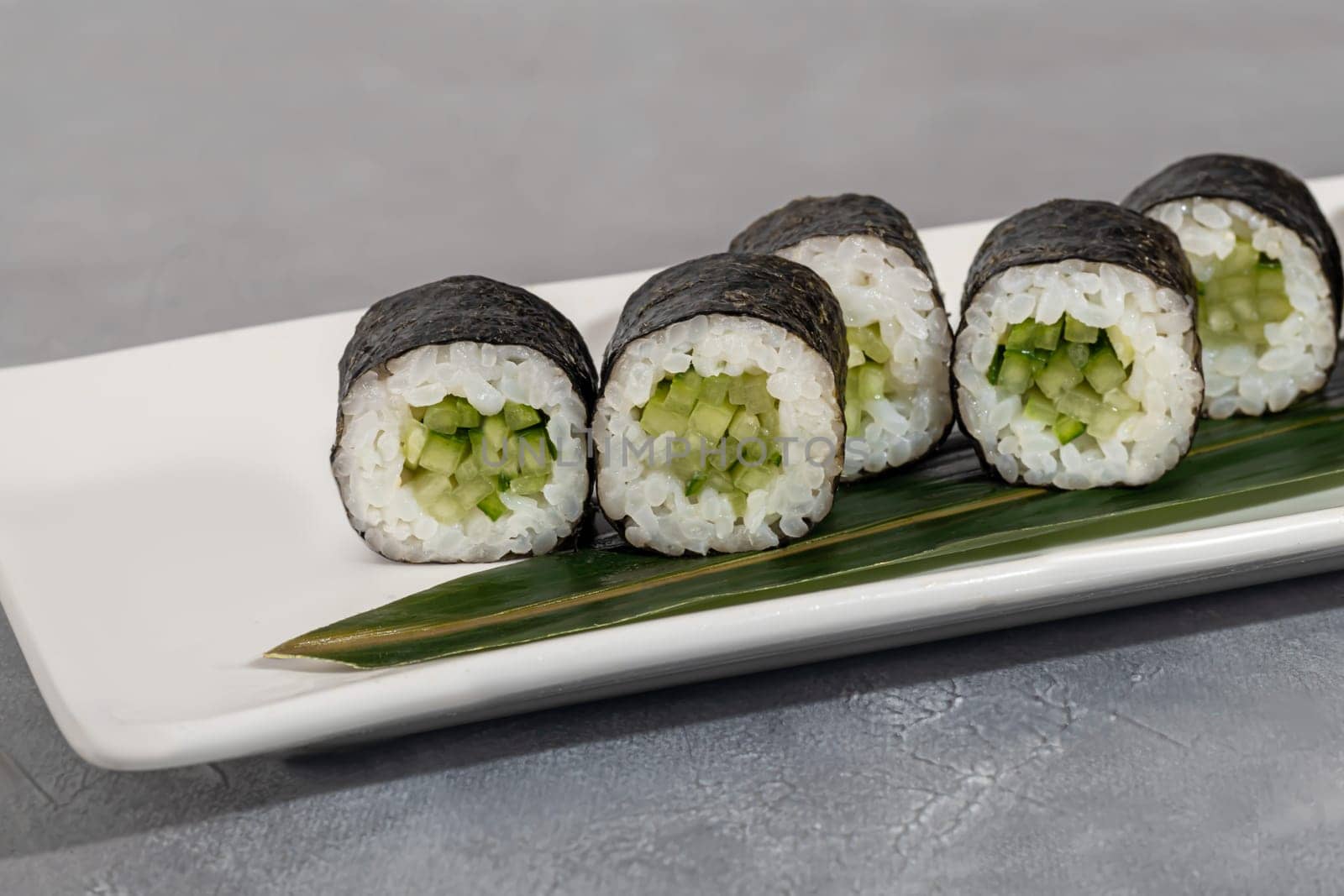 Sushi and rolls with caviar, shrimp and tuna, avocado on a gray background. by klimatis019