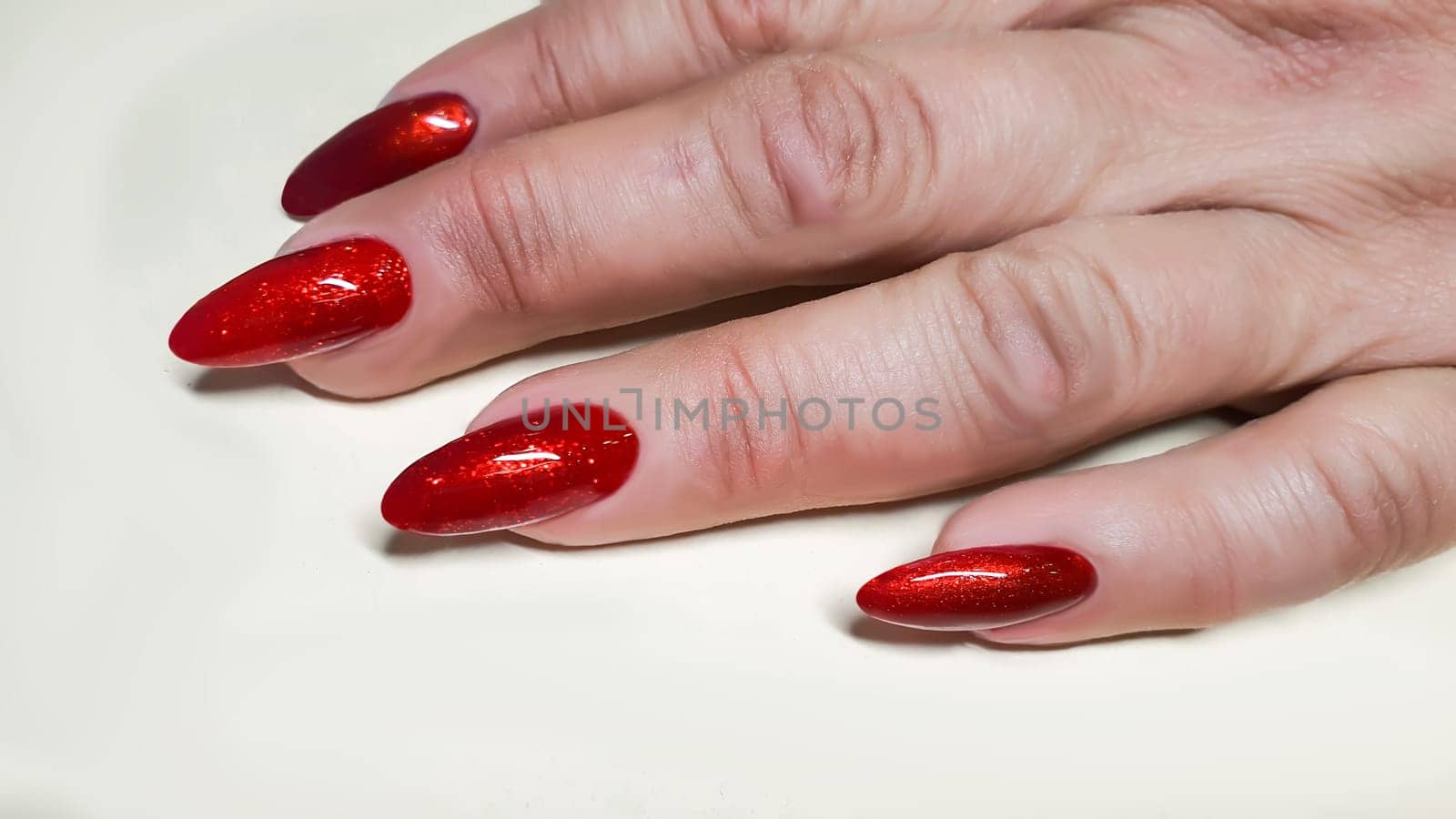 Manicure and nail extensions with acrylic and gel. The design is made with shiny gel polishes. Copy space