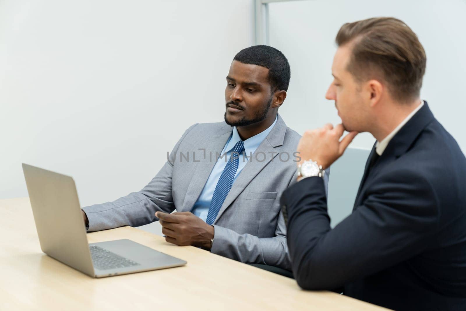 Cooperative handsome african businessman present start up project while manager listen and decide to invest. Two businesspeople making agreement, reporting data. Multicultural business. Ornamented.