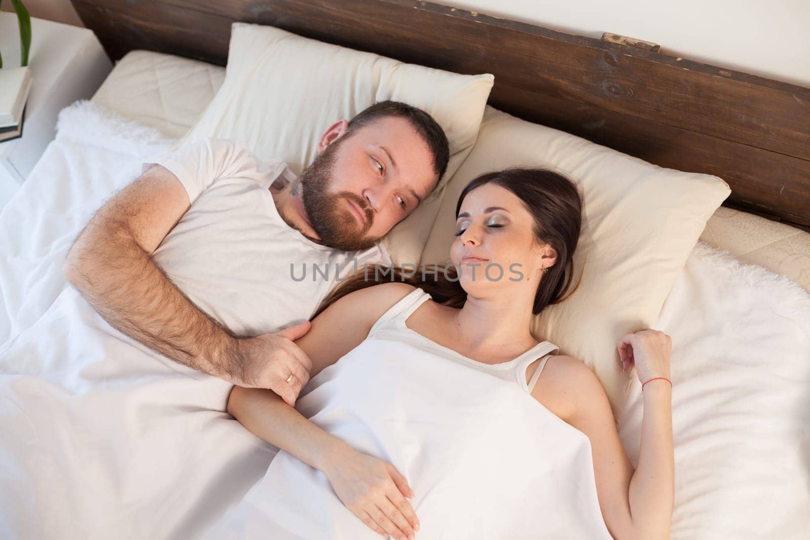 a man with a woman sleeping in beds bedroom 1