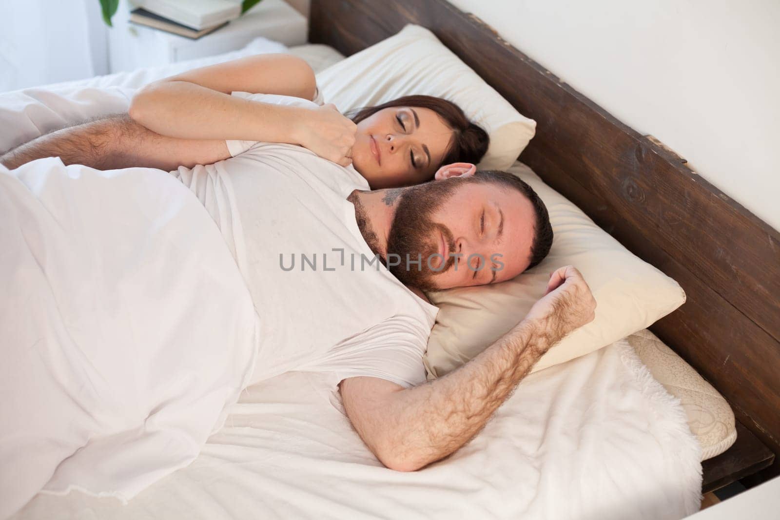 a man with a woman sleeping in beds bedroom 1