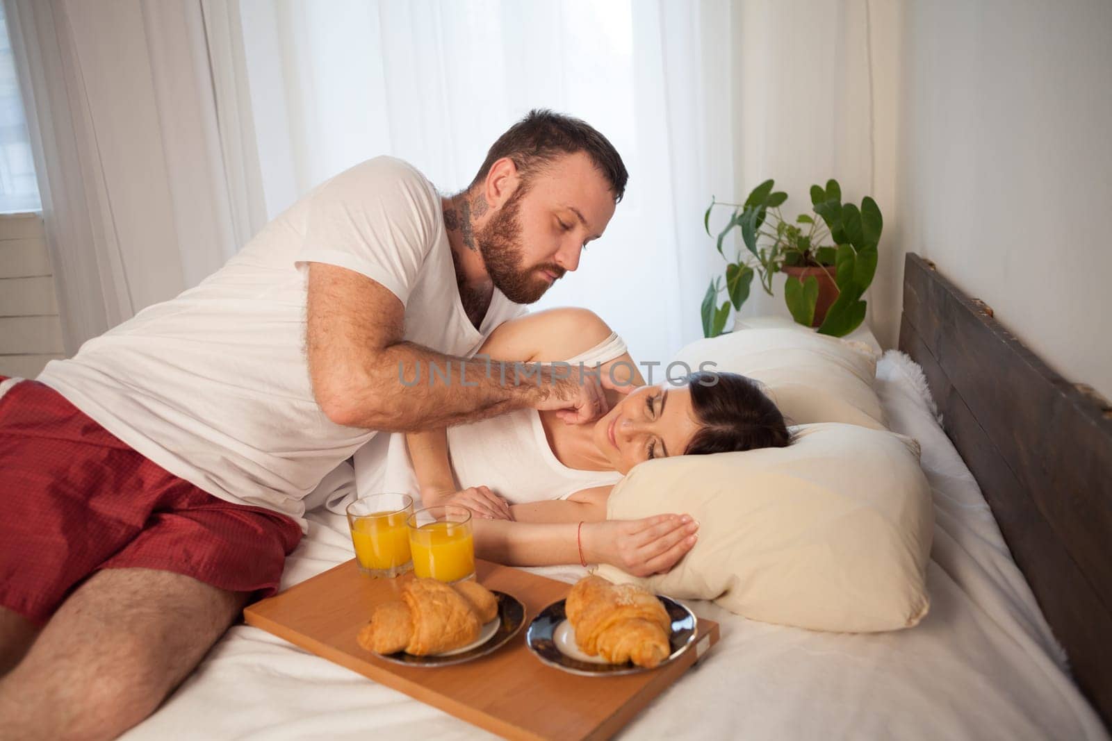 a man and a woman in the morning breakfast in bed 1