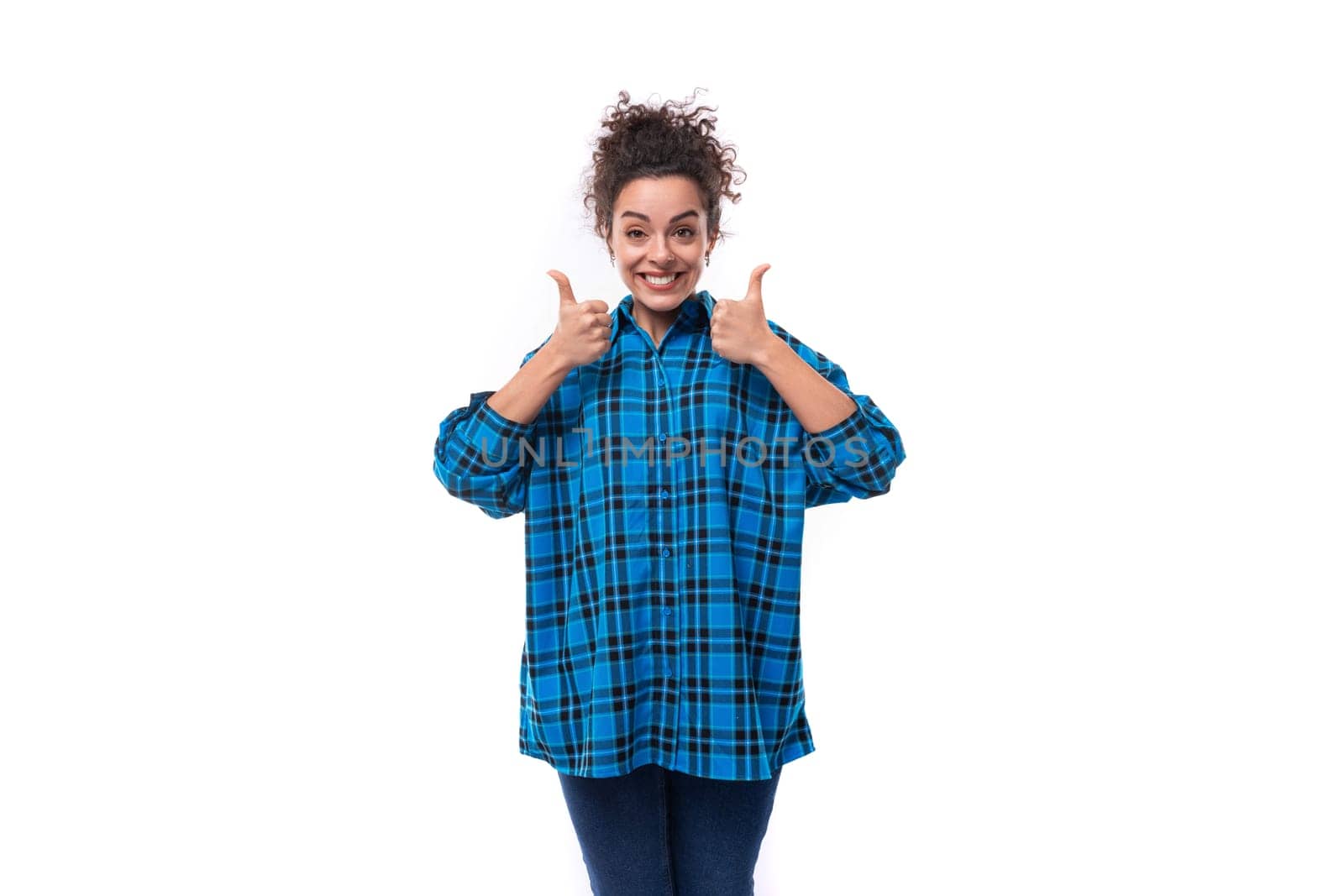portrait of a young pretty woman with curled hair smiling on a white background.