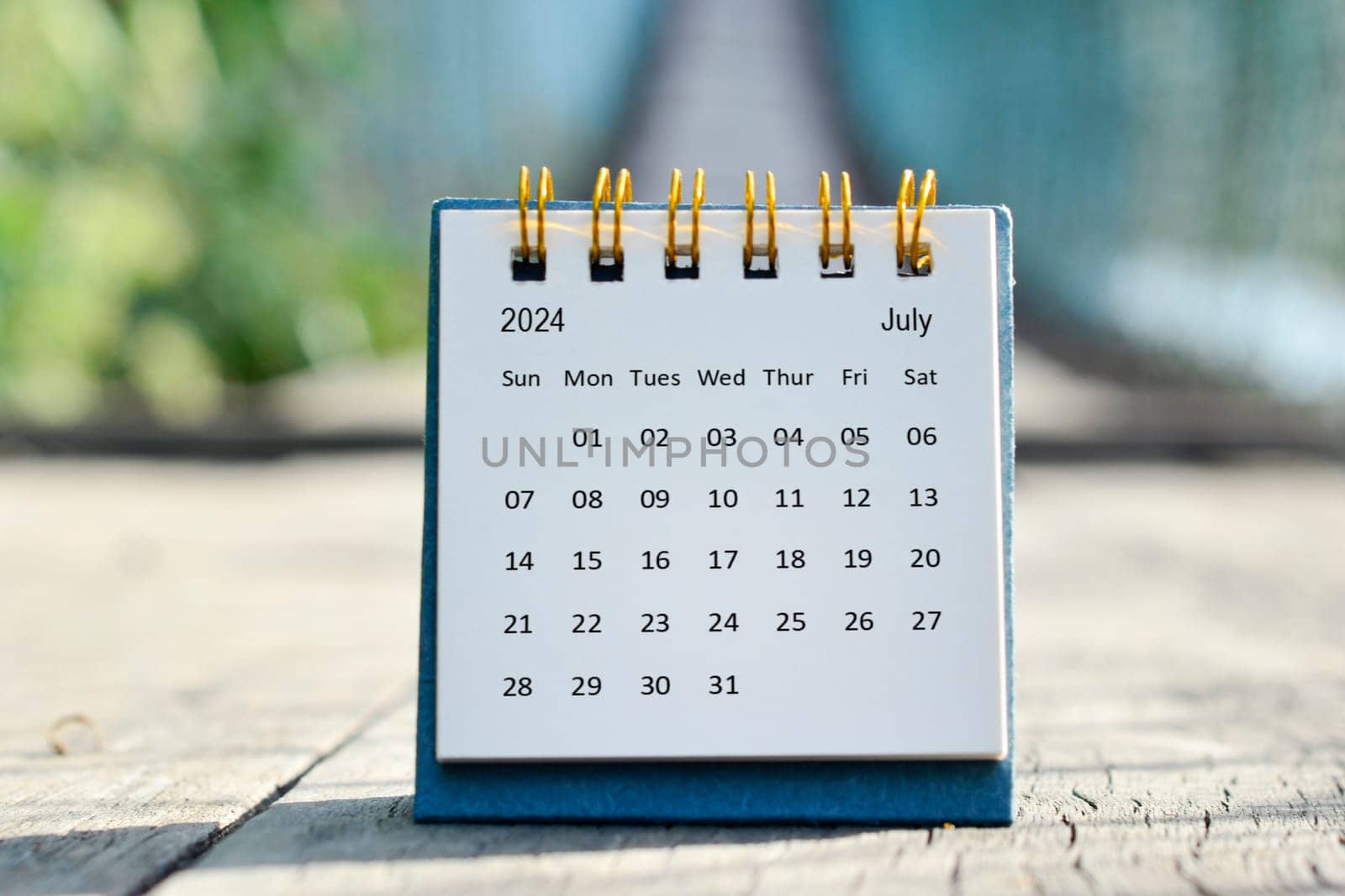July 2024 white calendar with green blurred background. 2024 new year concept.
