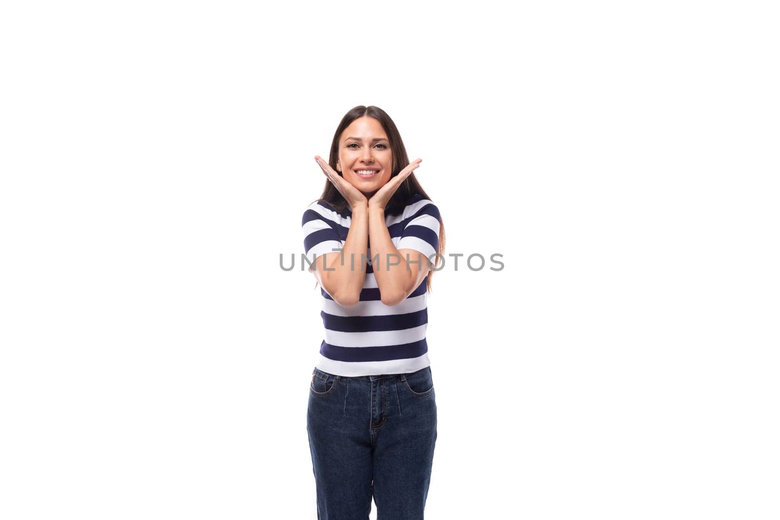 energetic young caucasian brunette woman in a striped t-shirt rejoices on a white background with copy space. advertising concept by TRMK