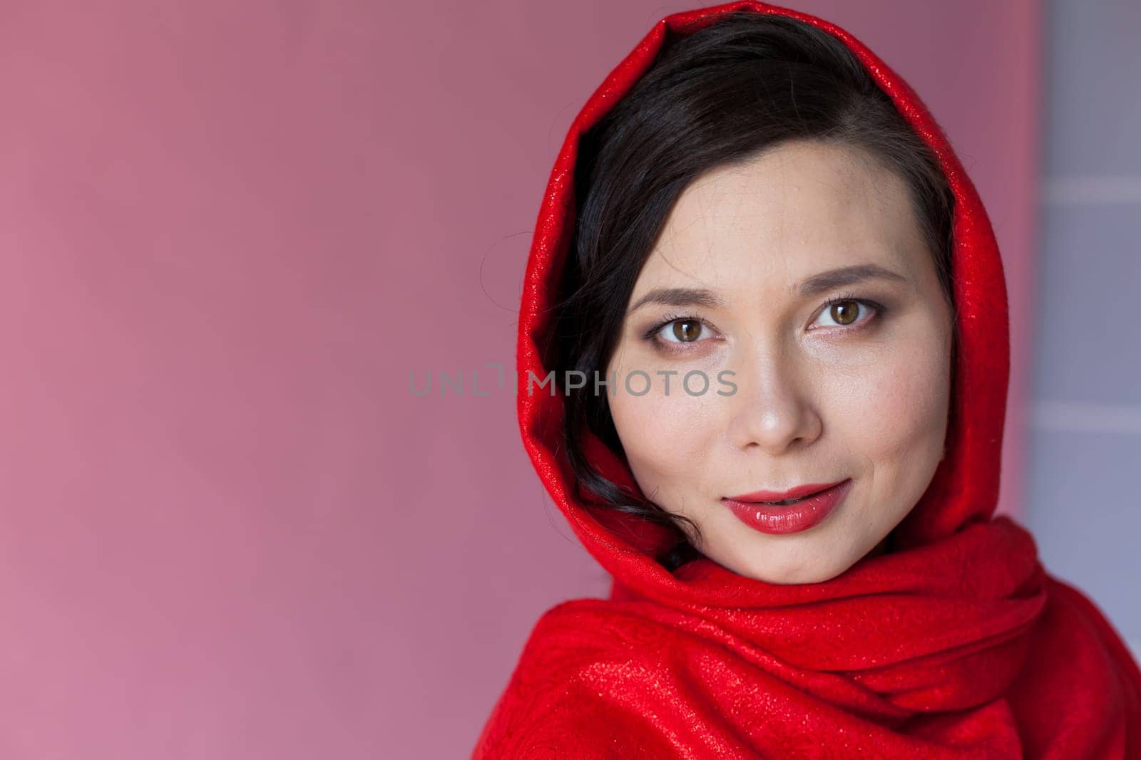 Portrait of a beautiful Asian woman with a red headscarf on her head by Simakov