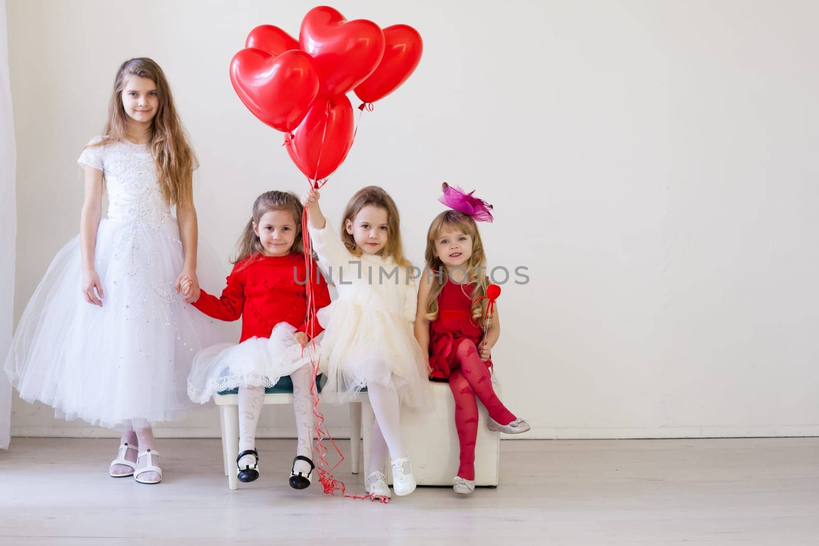 beautiful girls in red and white clothes on birthday party by Simakov