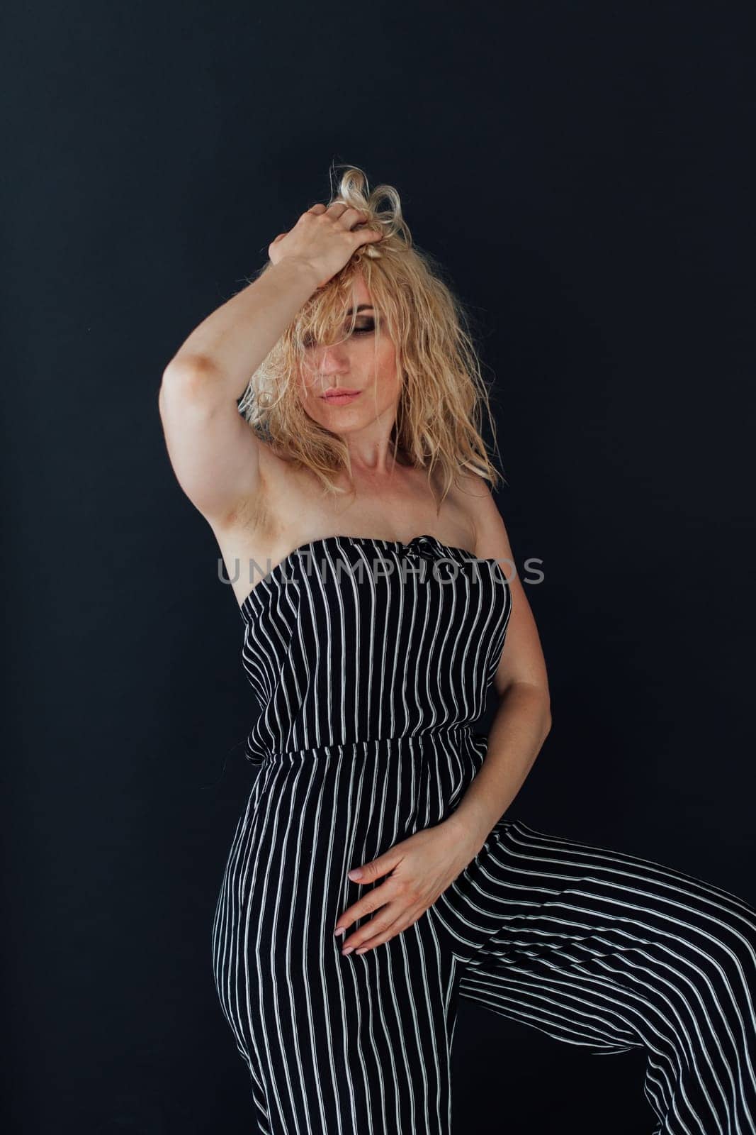 Portrait of a beautiful blonde woman in striped clothes