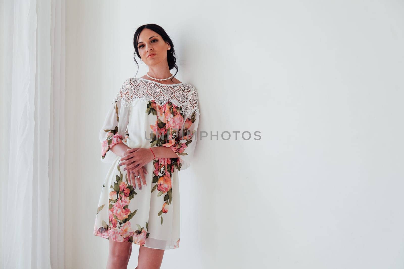 Portrait of a fashionable woman in a dress with flowers