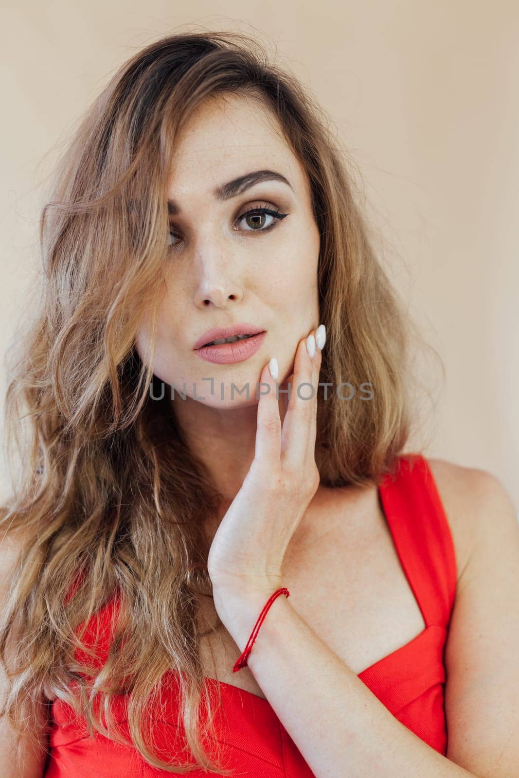 Portrait of a beautiful woman in a red business suit in the office