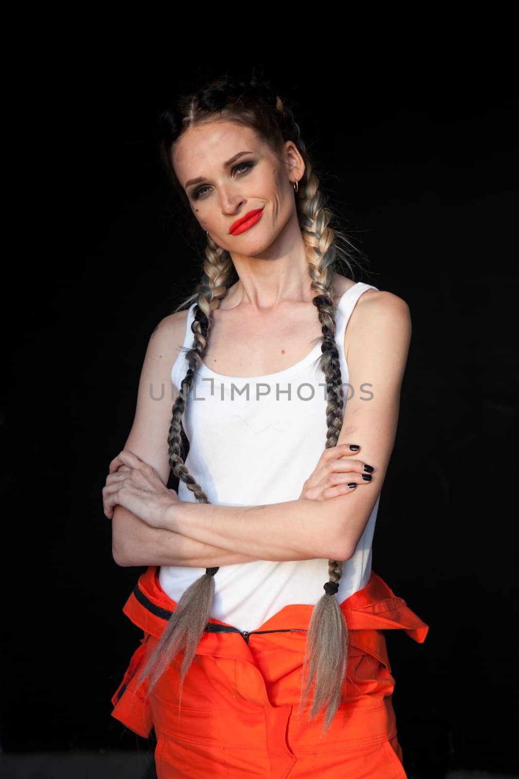 Beautiful female mechanic in work clothes braids mechanim by Simakov