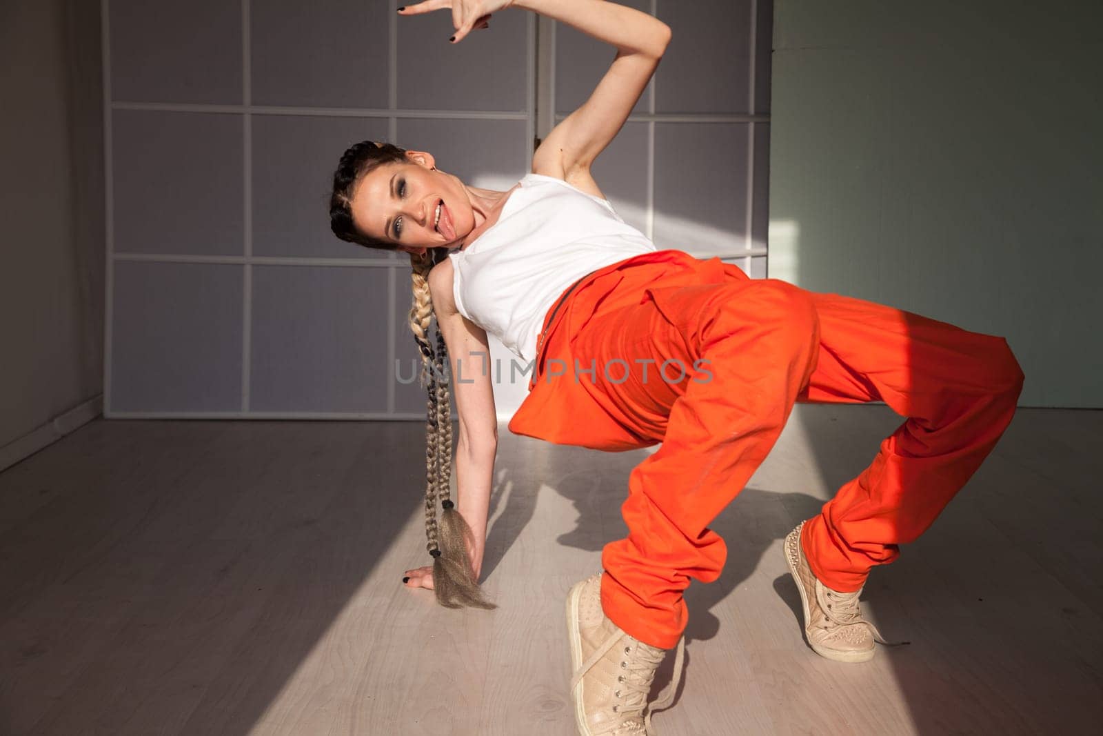 woman braids dancing alone to music