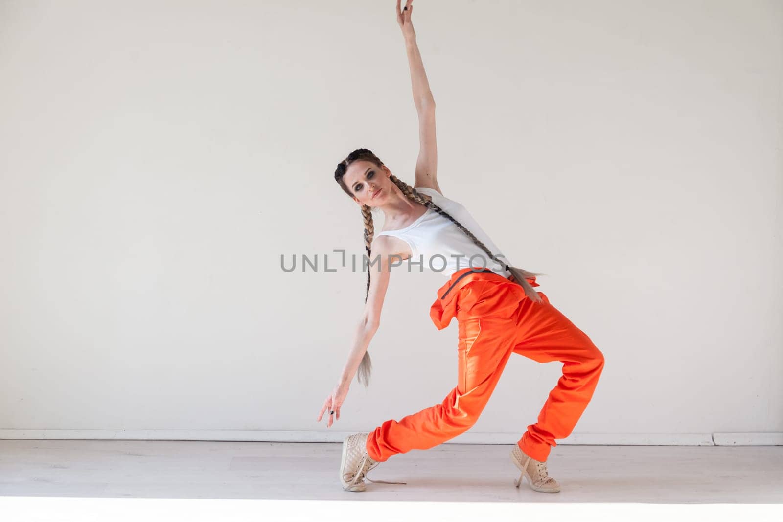 woman braids dancing alone to music