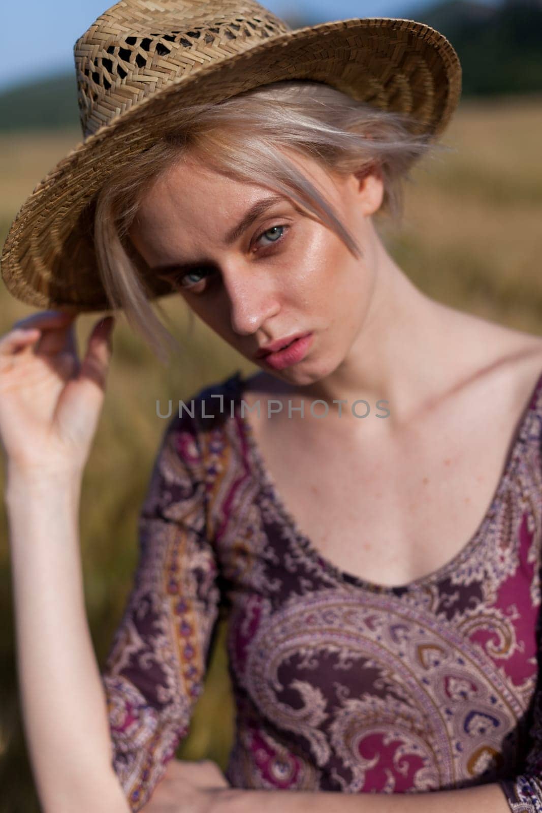 Beautiful fashionable woman blonde in a dress in a wheat field by Simakov