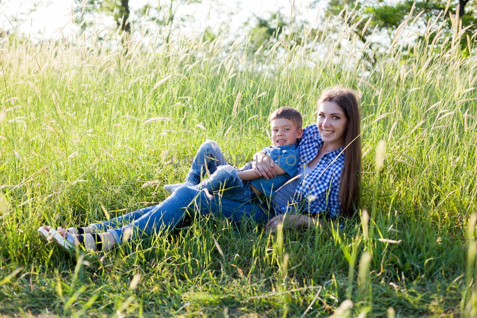 Portrait of a woman with her son on a walk in nature