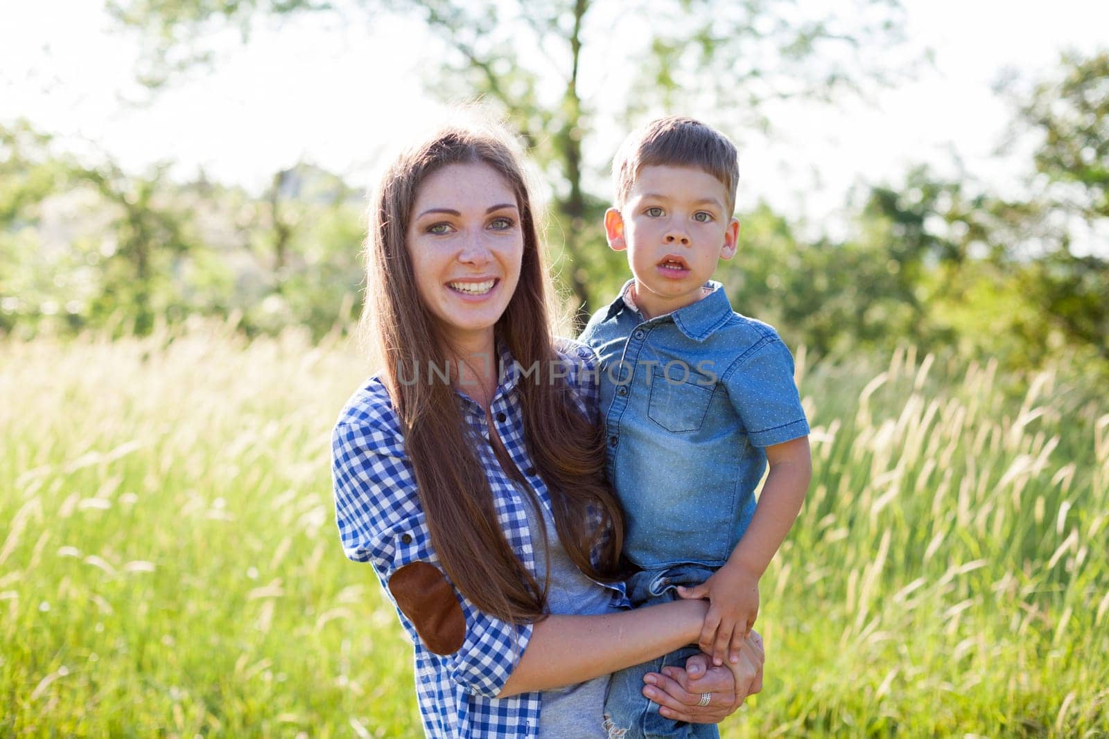 Portrait of a woman with her son on a walk in nature