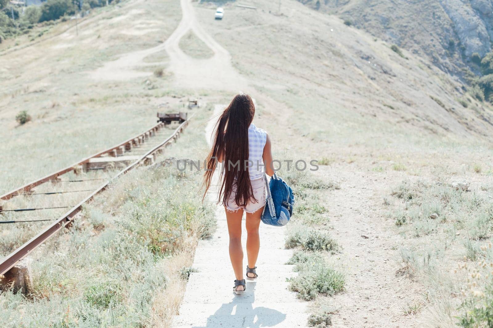 woman with long hair descends from the mountain