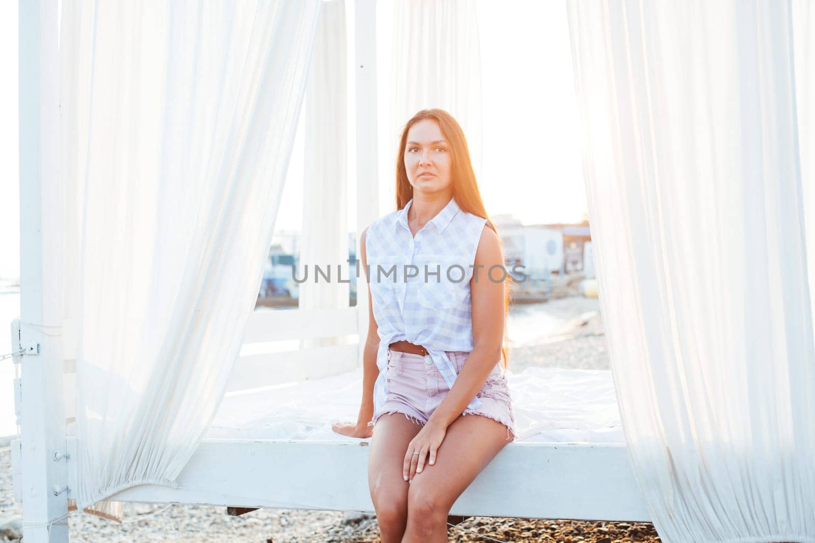 portrait of a woman with long hair on the beach by the sea