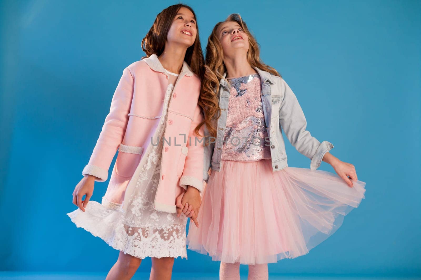 Two beautiful girl girlfriends in pink and white dresses