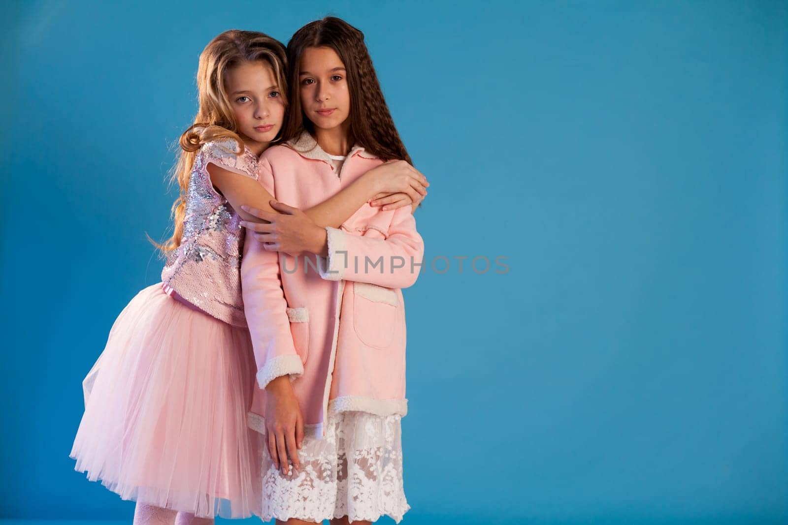 Two beautiful girl girlfriends in pink and white dresses