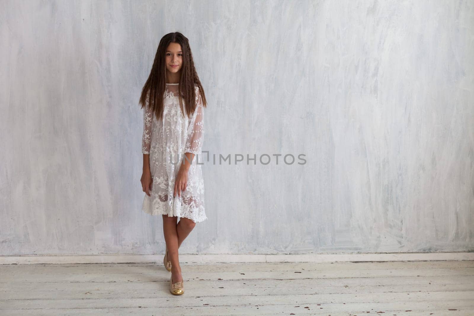 Portrait of a beautiful fashionable girl in a white dress by Simakov