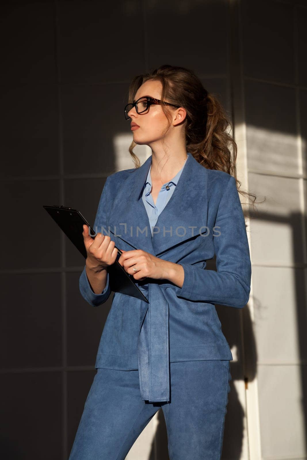 portrait of a business woman in a business suit at work in the office