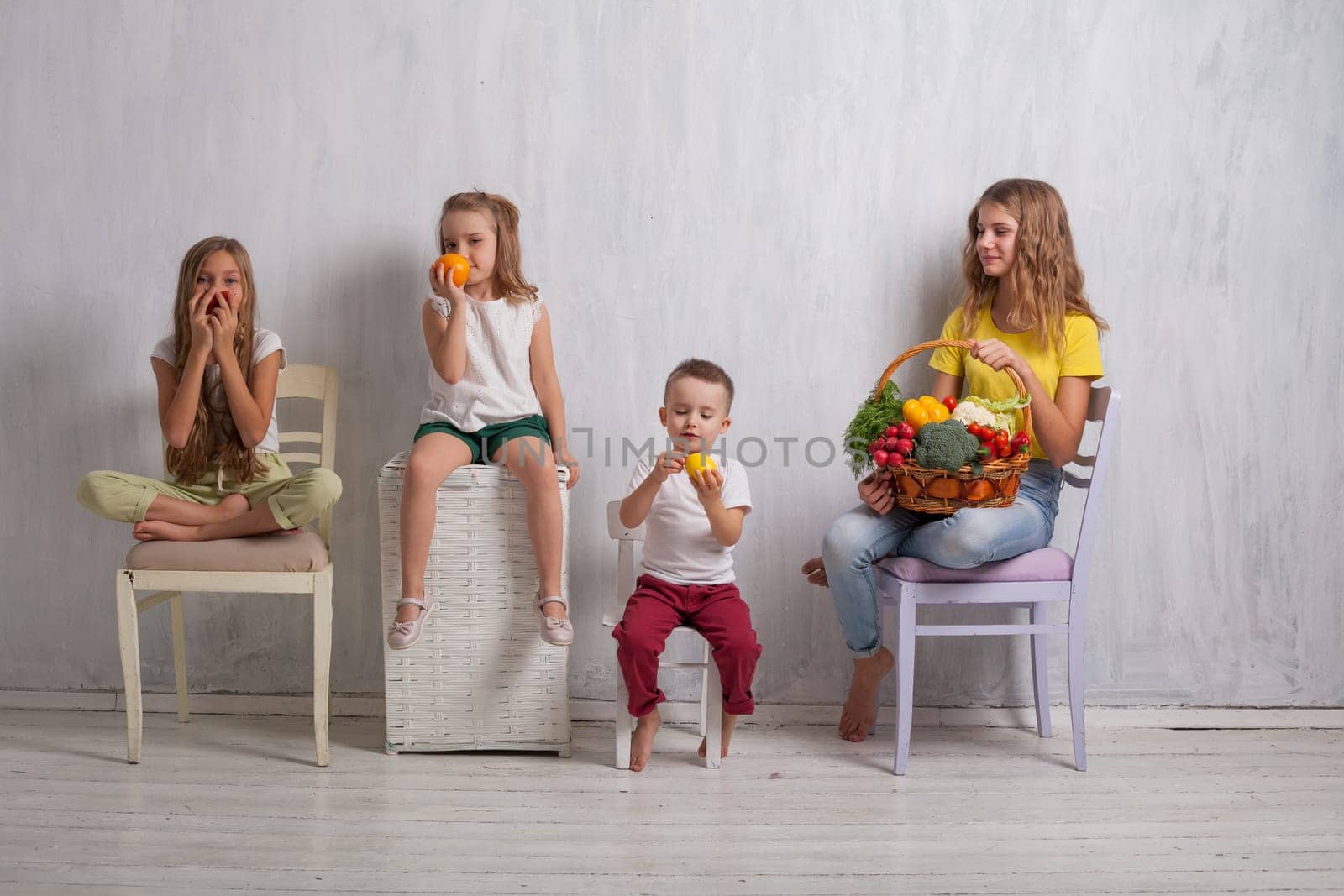 beautiful kids friends family with a basket of ripe vegetables and fruits