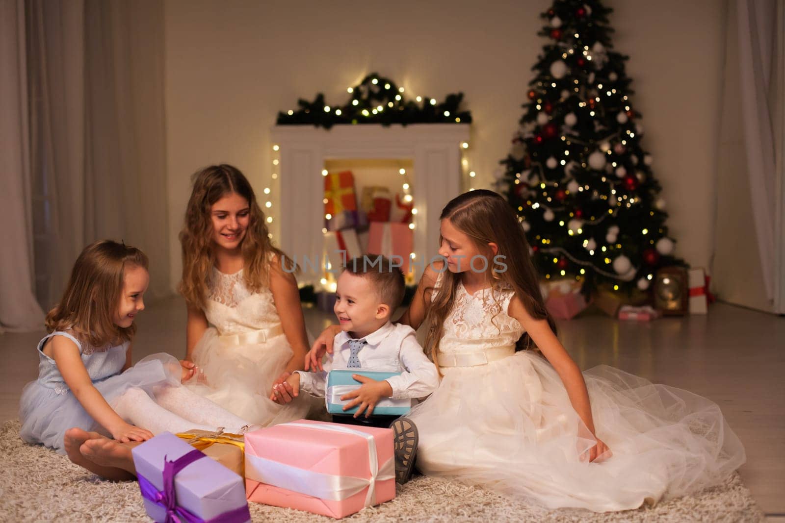 Kids family friends open gifts at New Year's Christmas Tree
