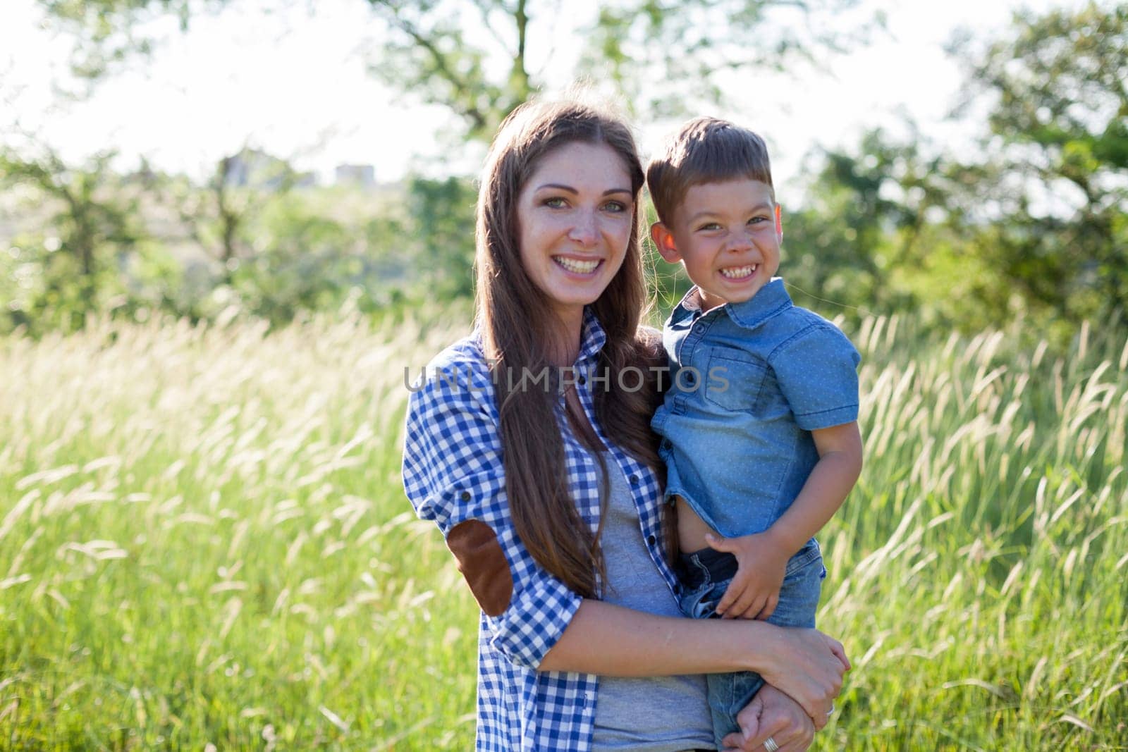 Portrait of a woman with her son on a walk in nature