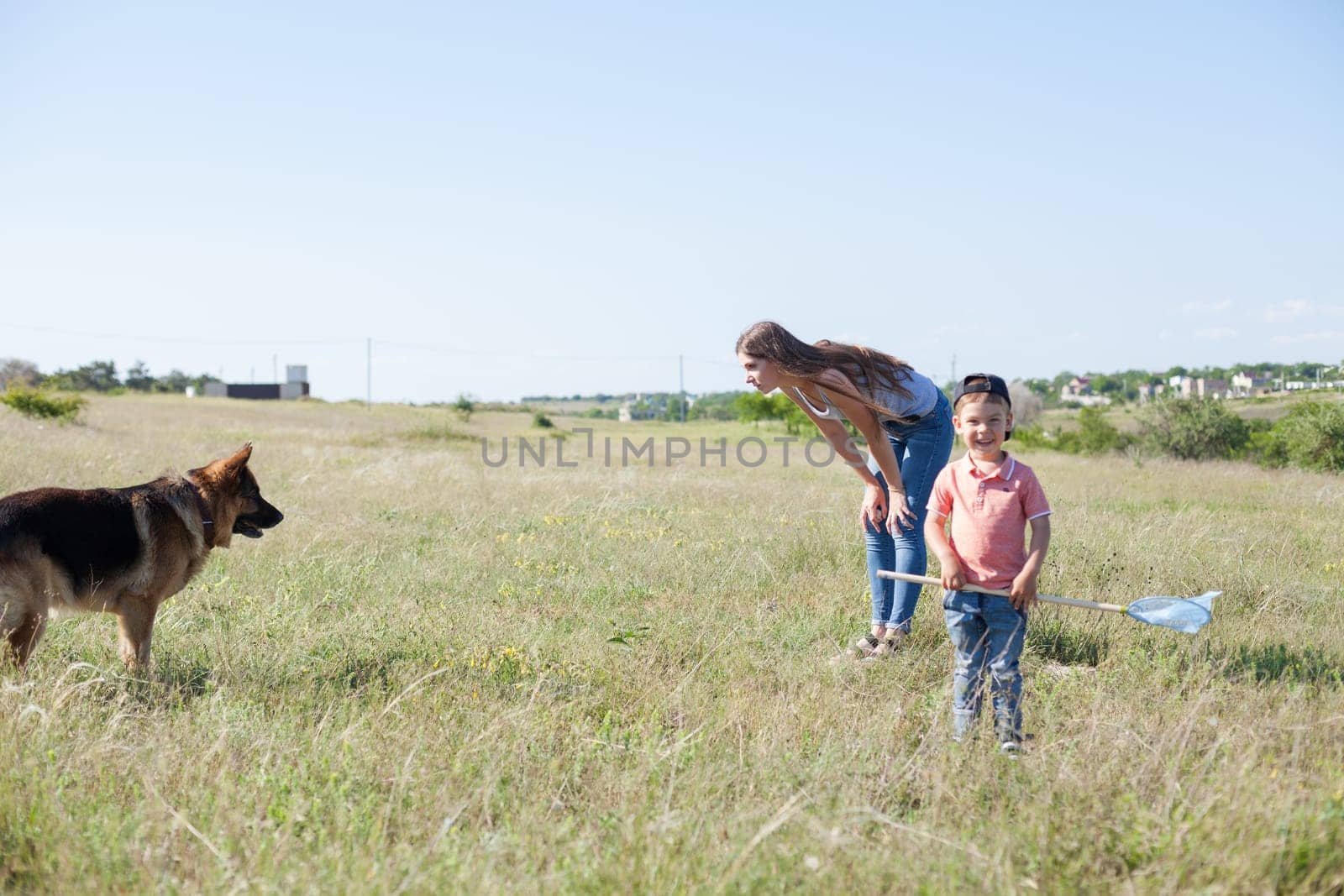 woman plays with german Shepherd dog on walk