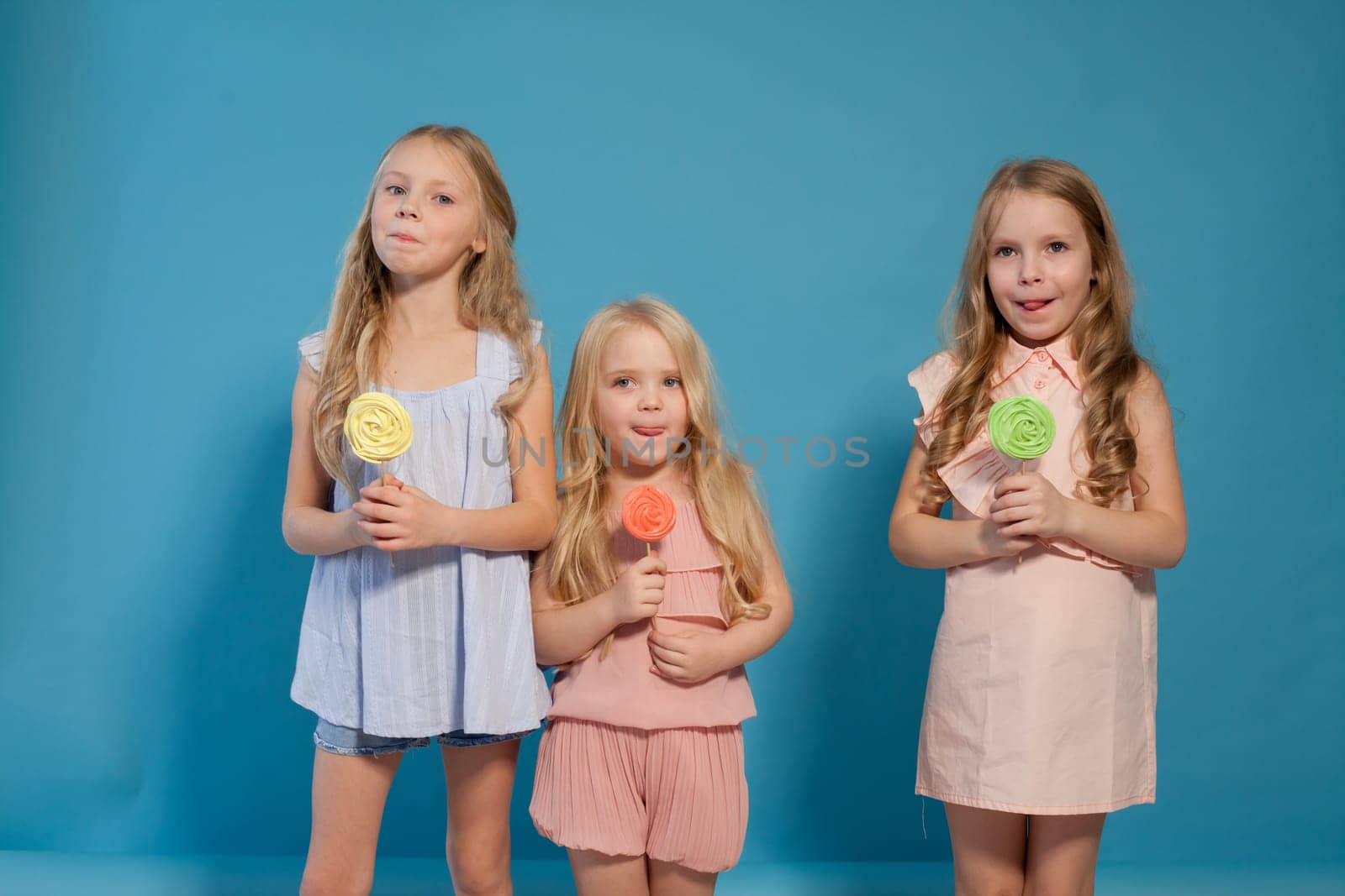 Two little girlfriend girls with sweet candy