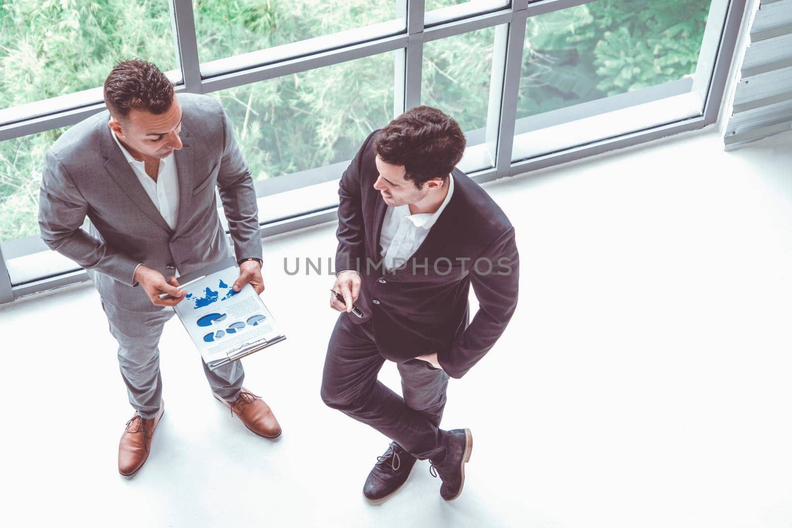 Businessman is in meeting discussion with another businessman partner in modern workplace office. People corporate business team concept. uds