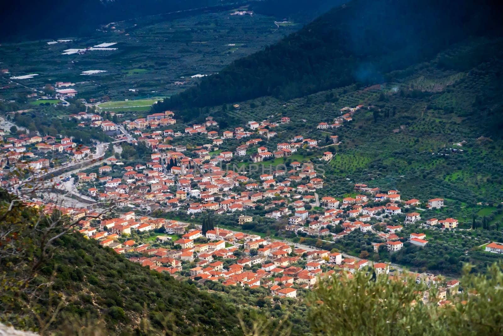 Scenic area of Leonidio, Arcadia, Greece with hills, rocks and small houses with red roofs on the coast, tourist and climbing resort.