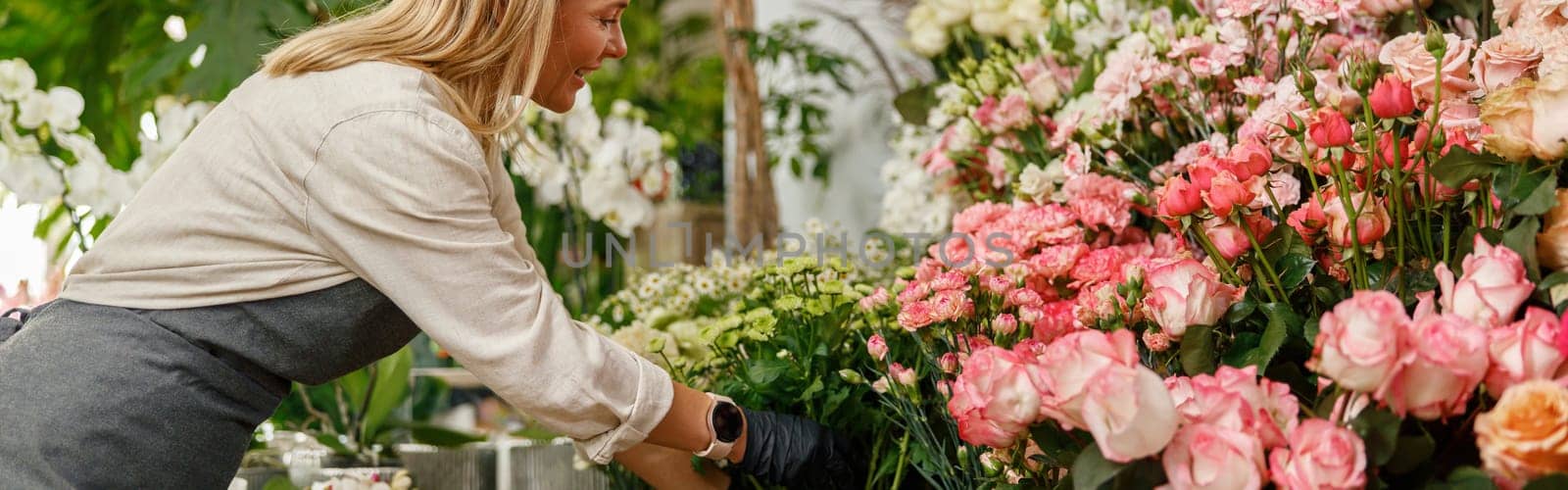 Woman florist small business owner standing in floral store. High quality photo