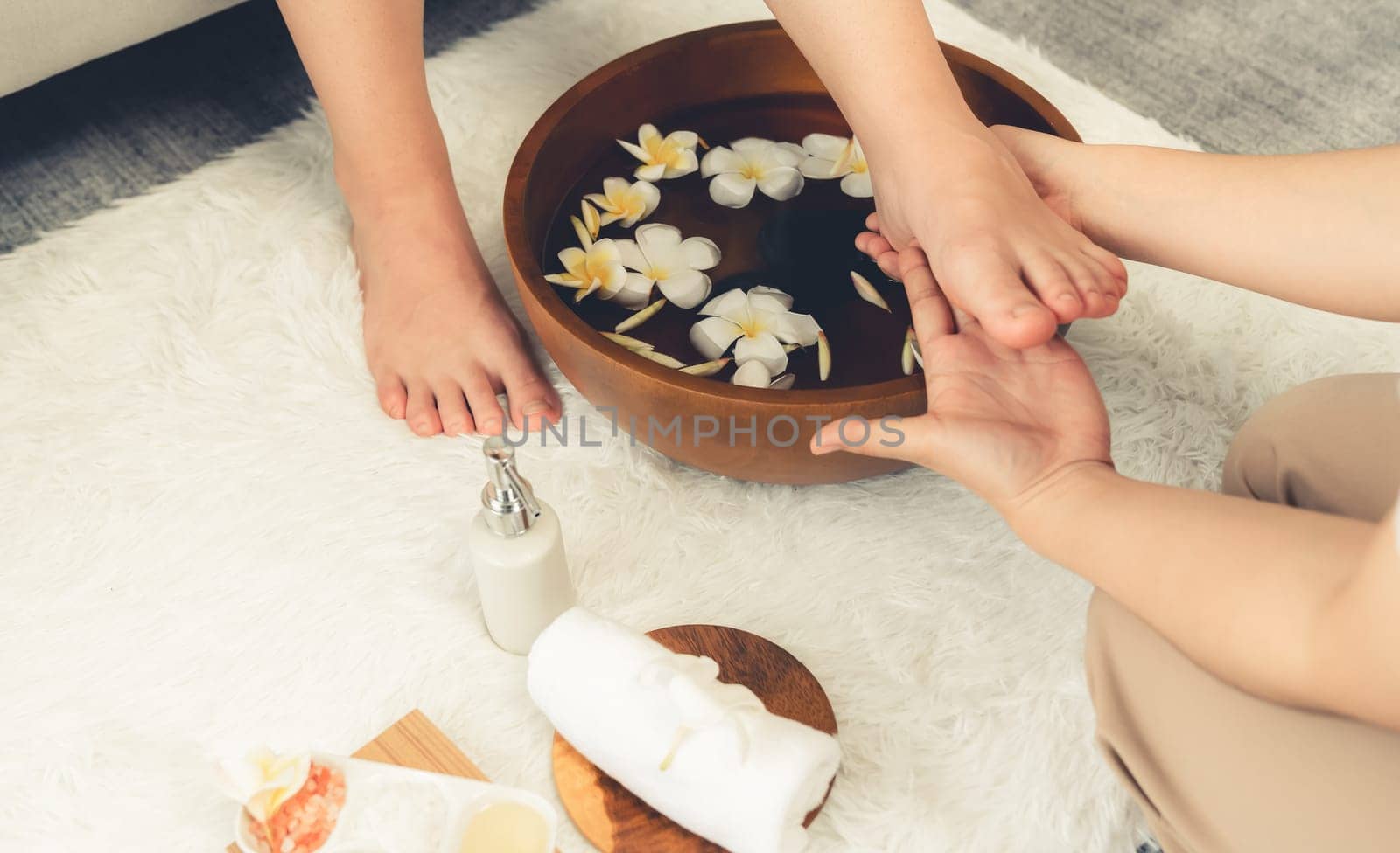 Woman indulges in blissful foot massage at luxurious spa salon. Quiescent by biancoblue