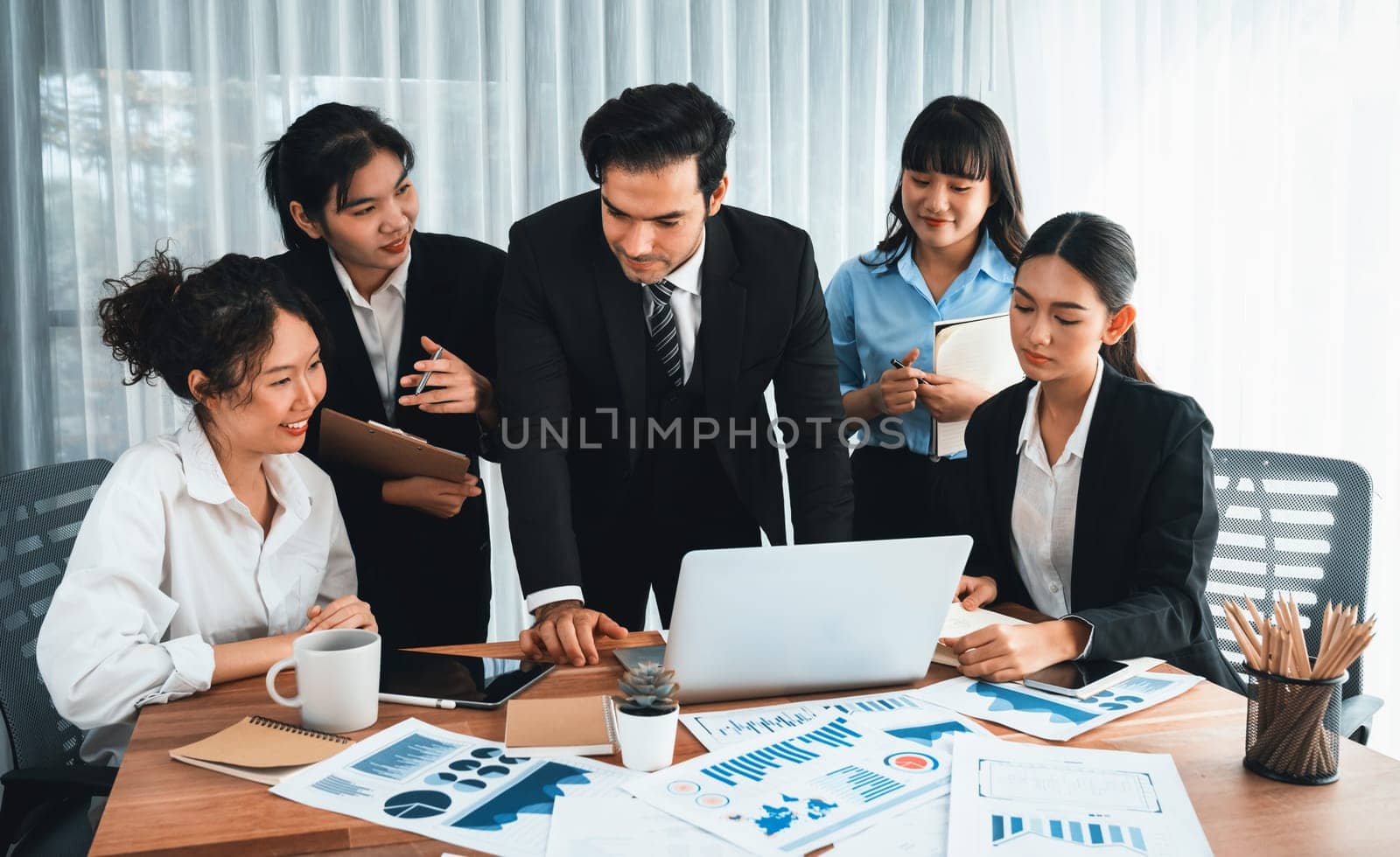 Diverse group of business analyst team analyzing financial data report paper on office table. Chart and graph dashboard by business intelligence analysis for strategic marketing planning Habiliment