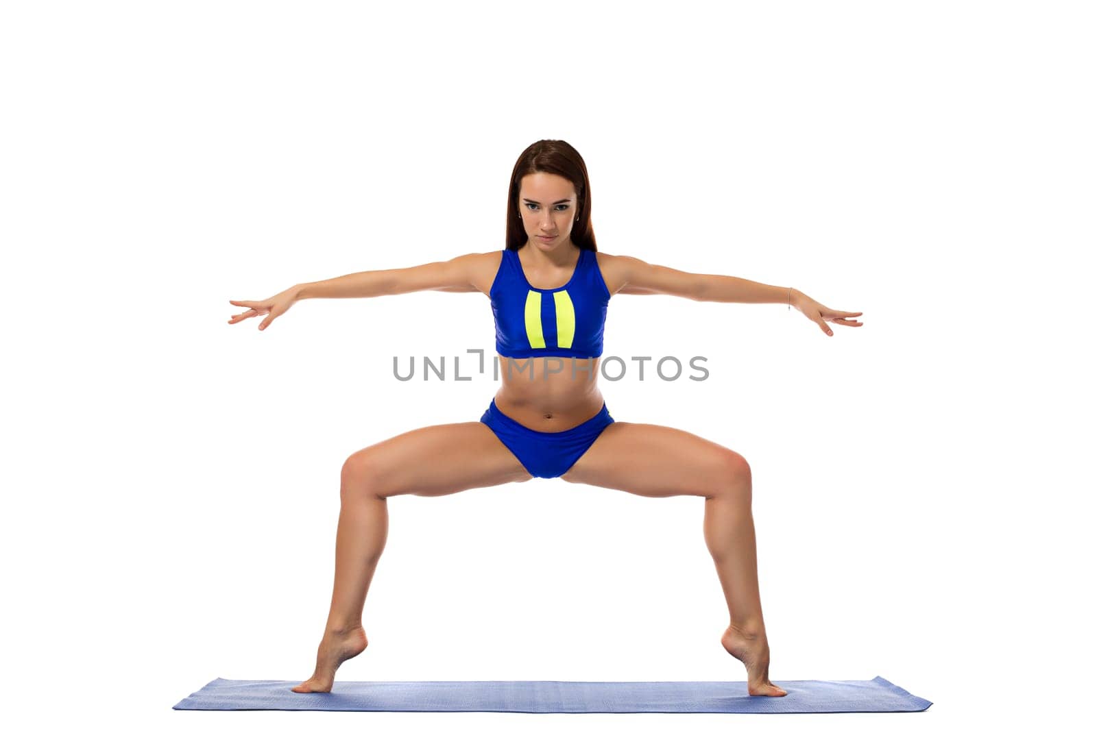 Studio shot of beautiful girl engaged in pilates by rivertime