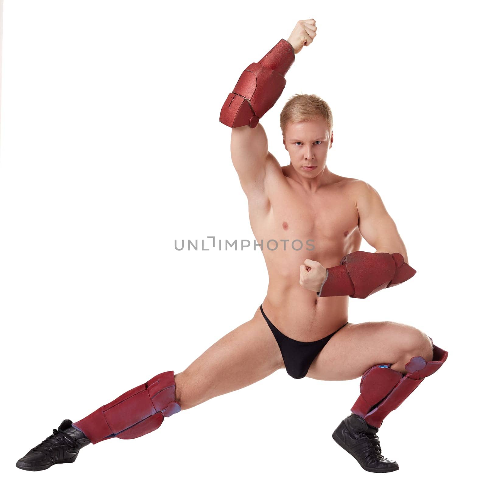 Gloomy muscular man posing in erotic costume of superhero