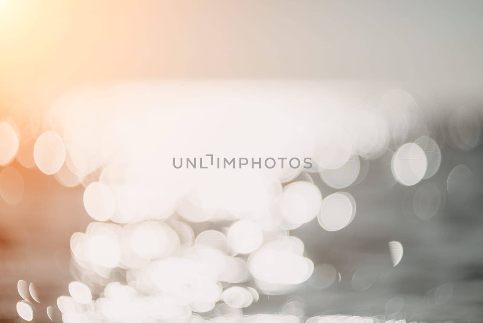 Abstract sea summer ocean sunset nature background. Sound of small waves on golden water surface in motion blur with golden bokeh lights from sun. Holiday, vacation and recreational concept.