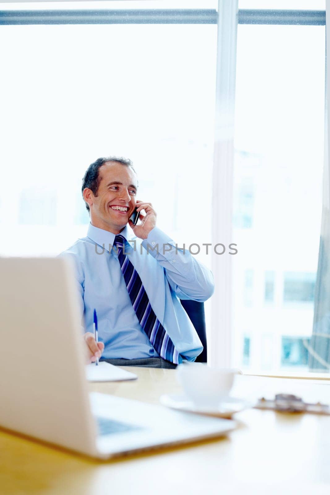 Businessman, phone call and smile for communication in modern office for discussion. Corporate, male manager and happy with technology for online consultation, listen and idea for financial planning by YuriArcurs