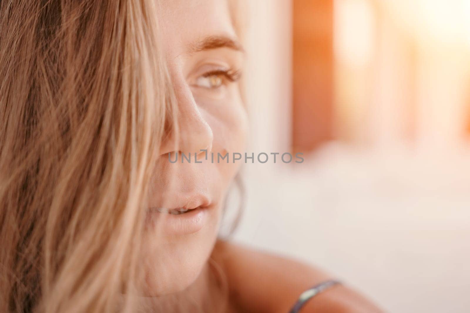 Happy woman portrait in cafe. Boho chic fashion style. Outdoor photo of young happy woman with long hair, sunny weather outdoors sitting in modern cafe. by panophotograph