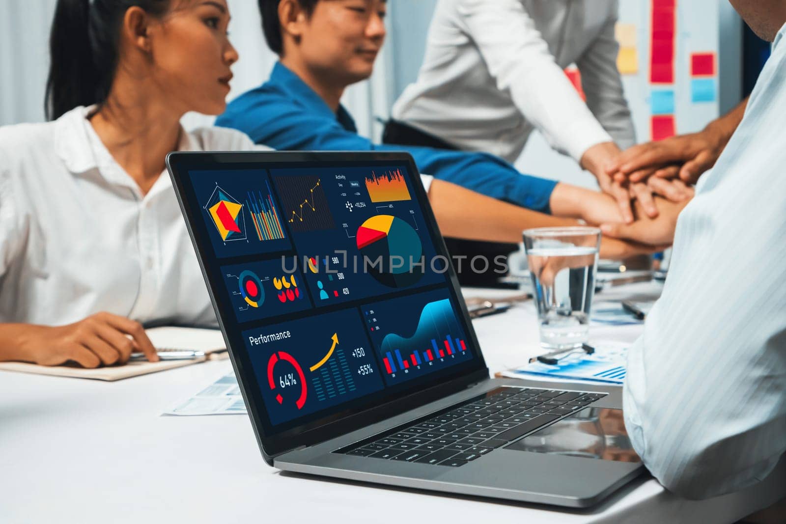 Bi dashboard display on laptop monitor analyzed Fintech technology empower effective financial data analyzing with background of analyst team join hand together symbolizing teamwork. Prudent
