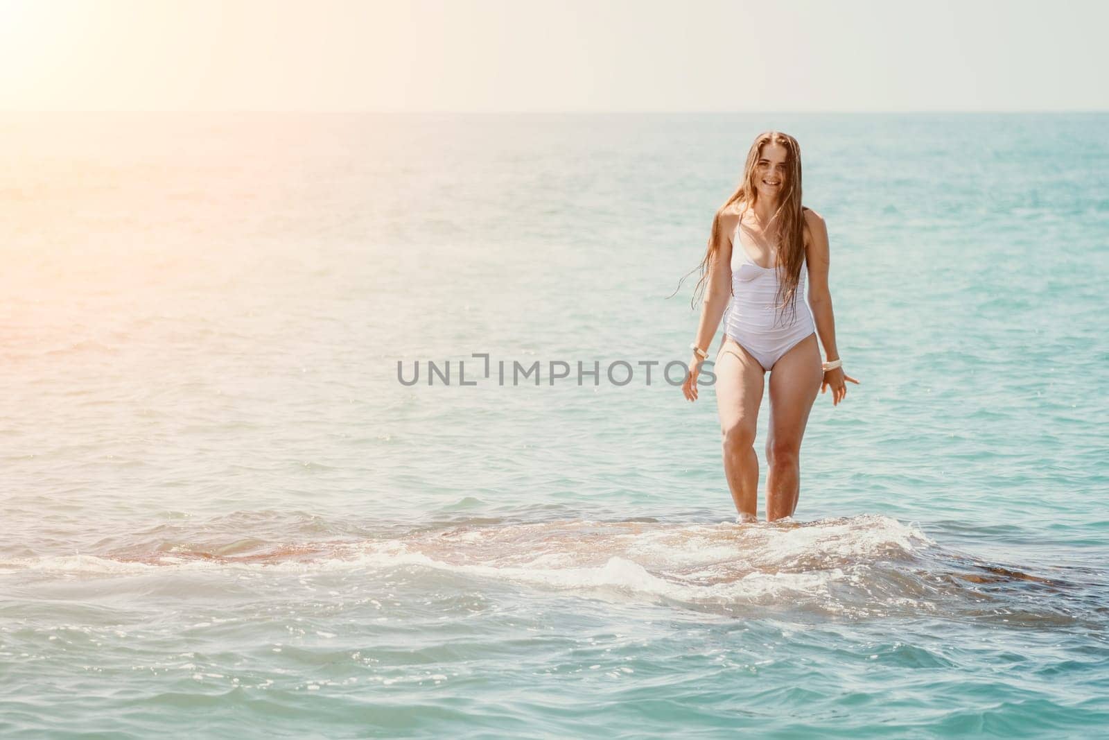 Woman sea yoga. Back view of free calm happy satisfied woman with long hair standing on top rock with yoga position against of sky by the sea. Healthy lifestyle outdoors in nature, fitness concept.