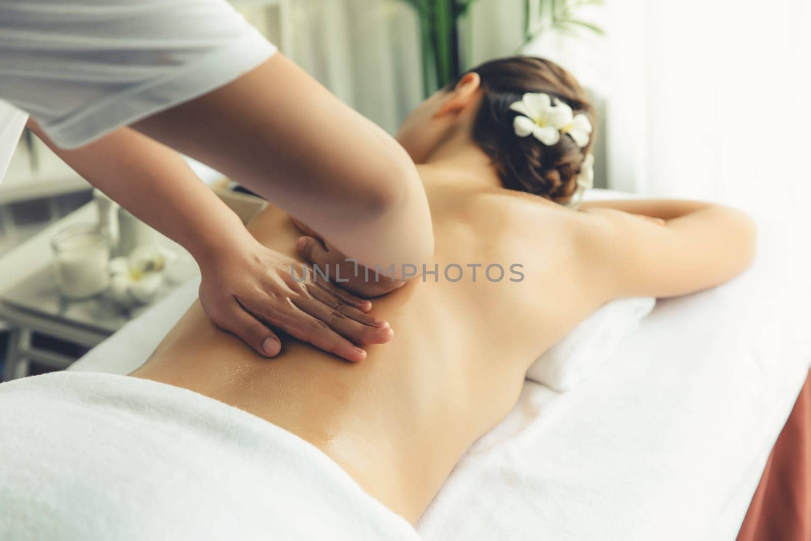 Caucasian woman customer enjoying relaxing anti-stress massage. Quiescent by biancoblue
