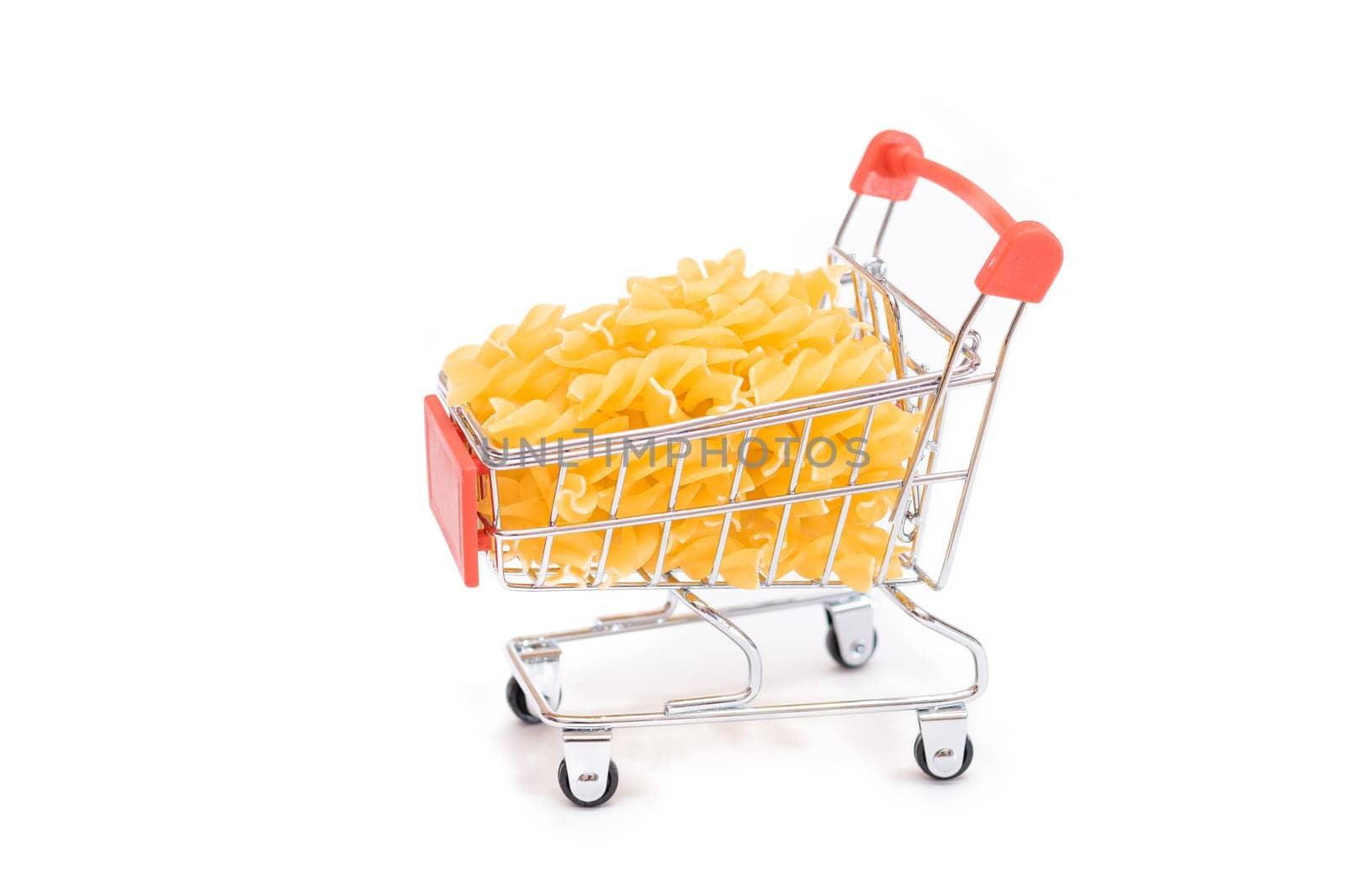Uncooked Fusilli Pasta in Small Shopping Cart Isolated on White by InfinitumProdux