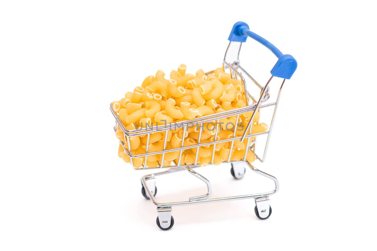 Uncooked Chifferi Rigati Pasta in Small Shopping Cart Isolated on White Background. A Crisis: Buying Cheap Food. Classic Dry Macaroni. Italian Culture and Cuisine. Raw Pasta - Isolation