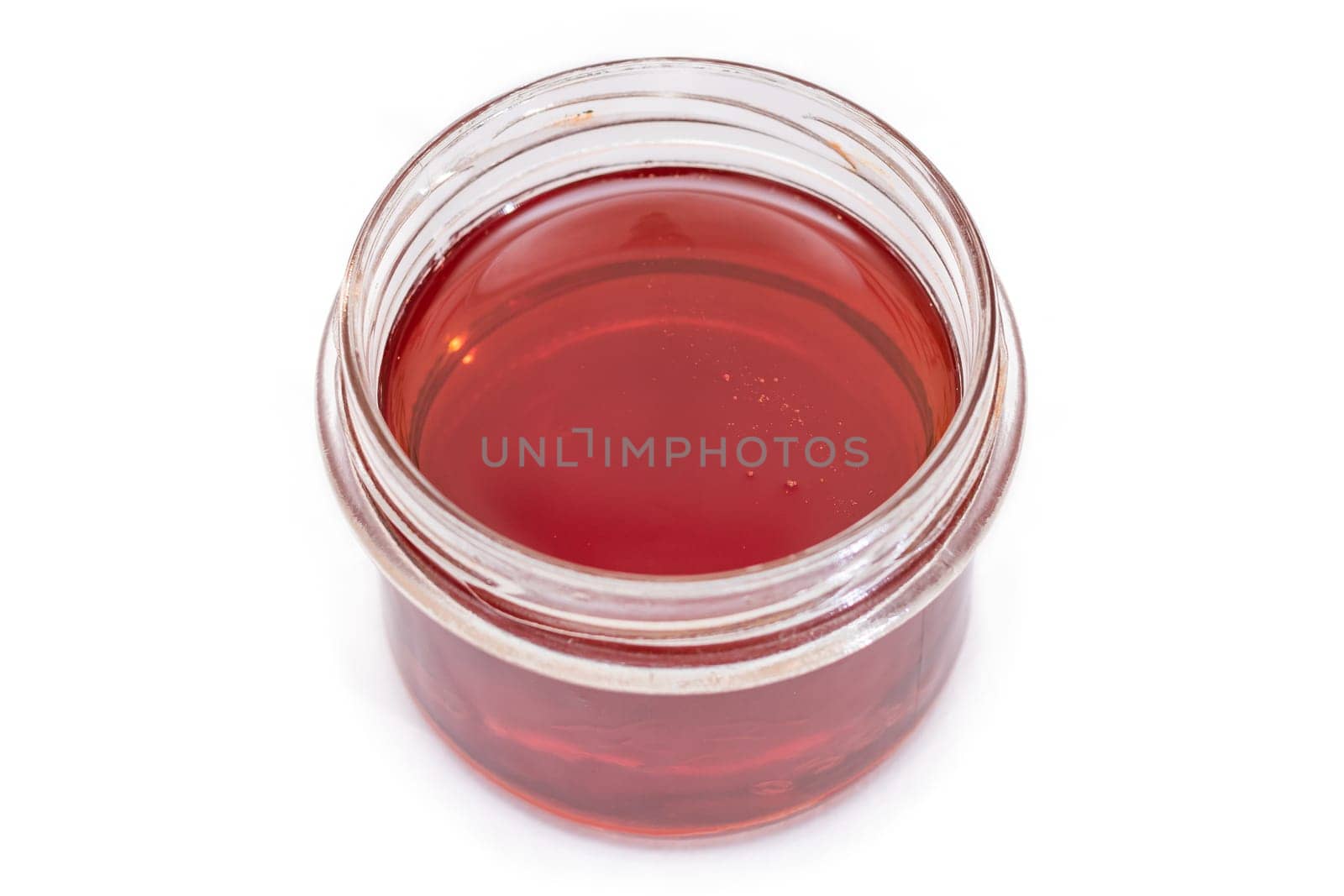 Dark Honey in a Small Glass Jar Isolated by InfinitumProdux